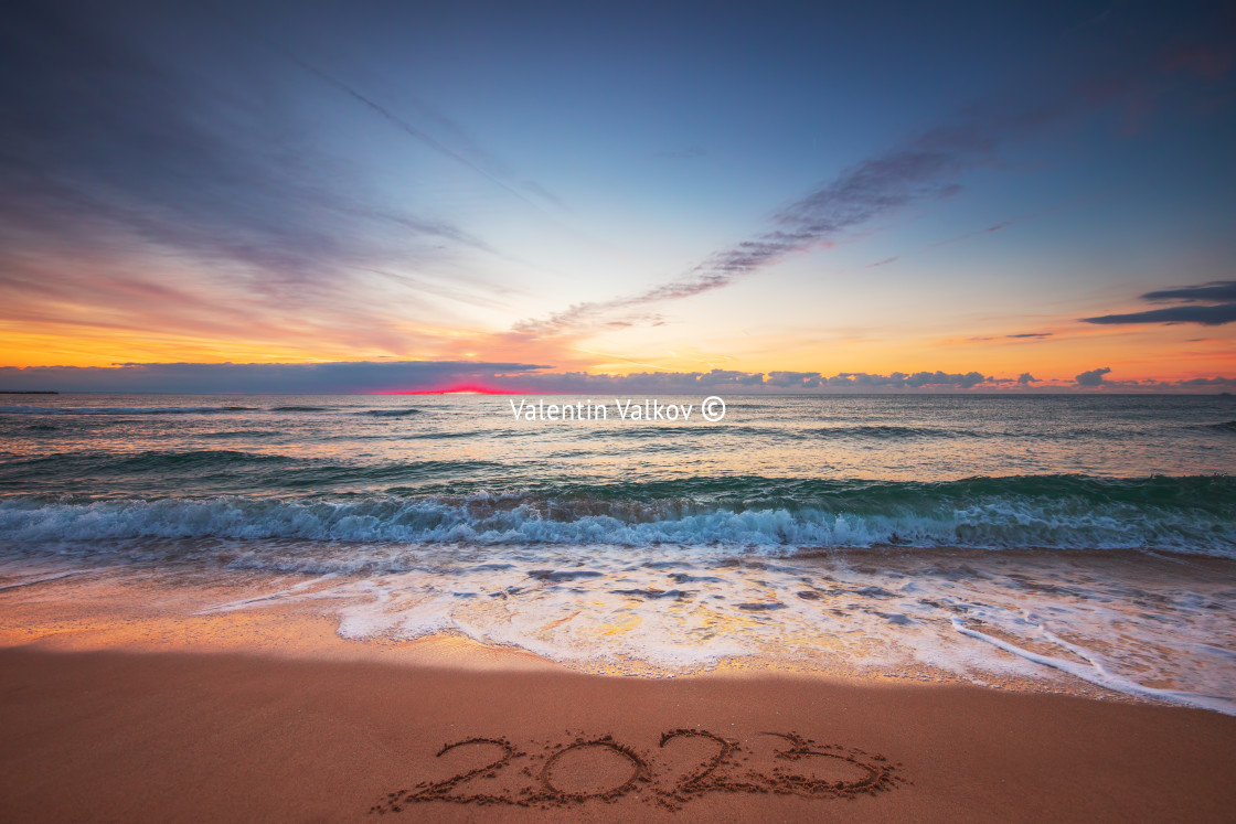 "Happy New Year 2023 concept, lettering on the beach. Written tex" stock image