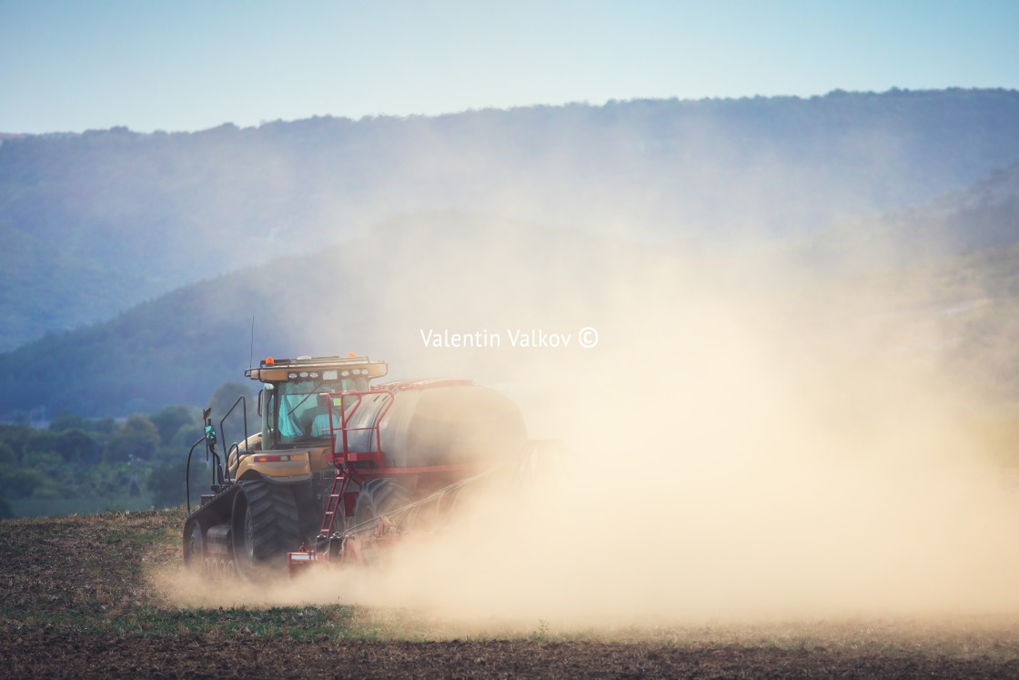 "Farmer in tractor preparing land with seedbed cultivator" stock image