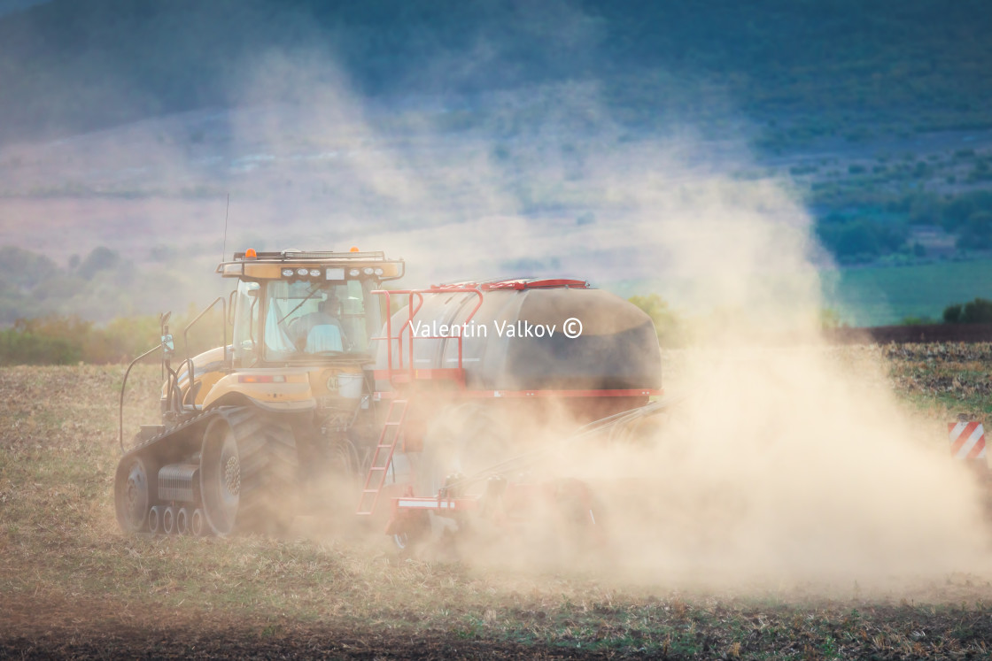 "Farmer in tractor preparing land with seedbed cultivator" stock image