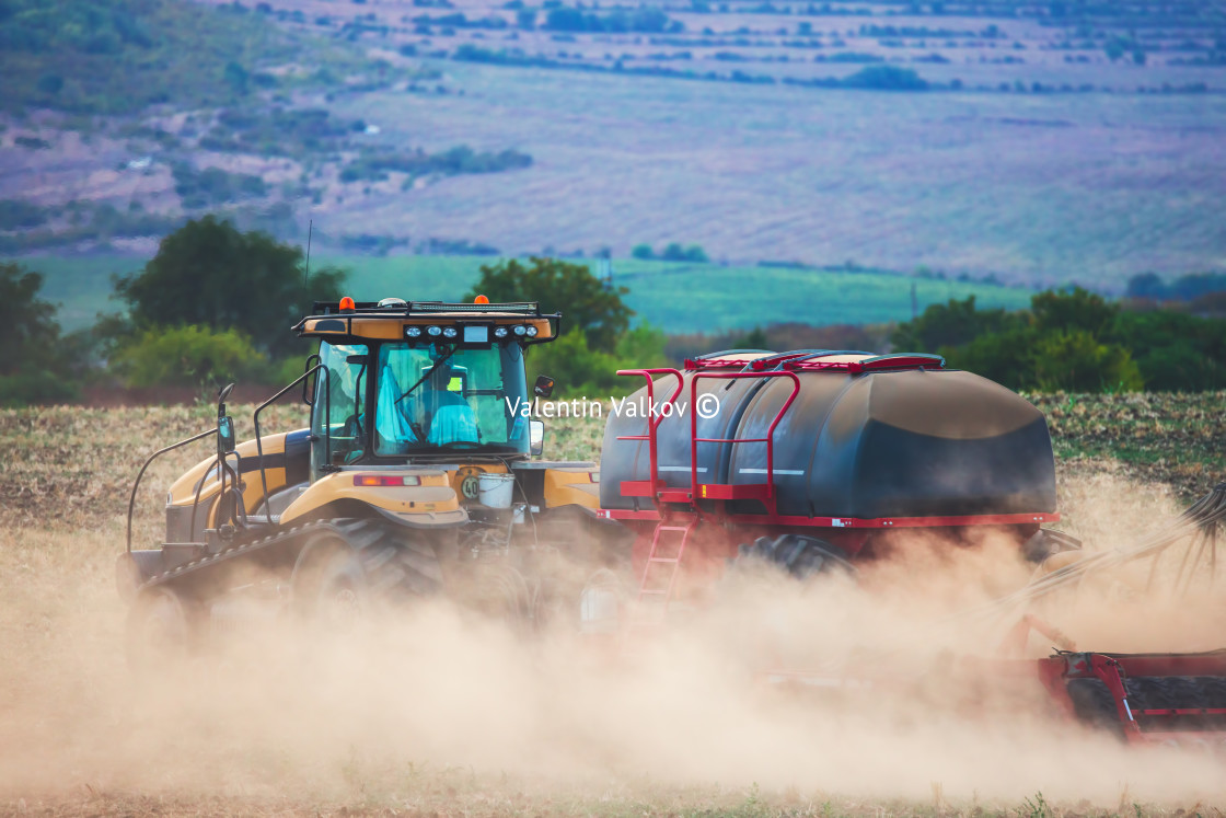 "Farmer in tractor preparing land with seedbed cultivator" stock image