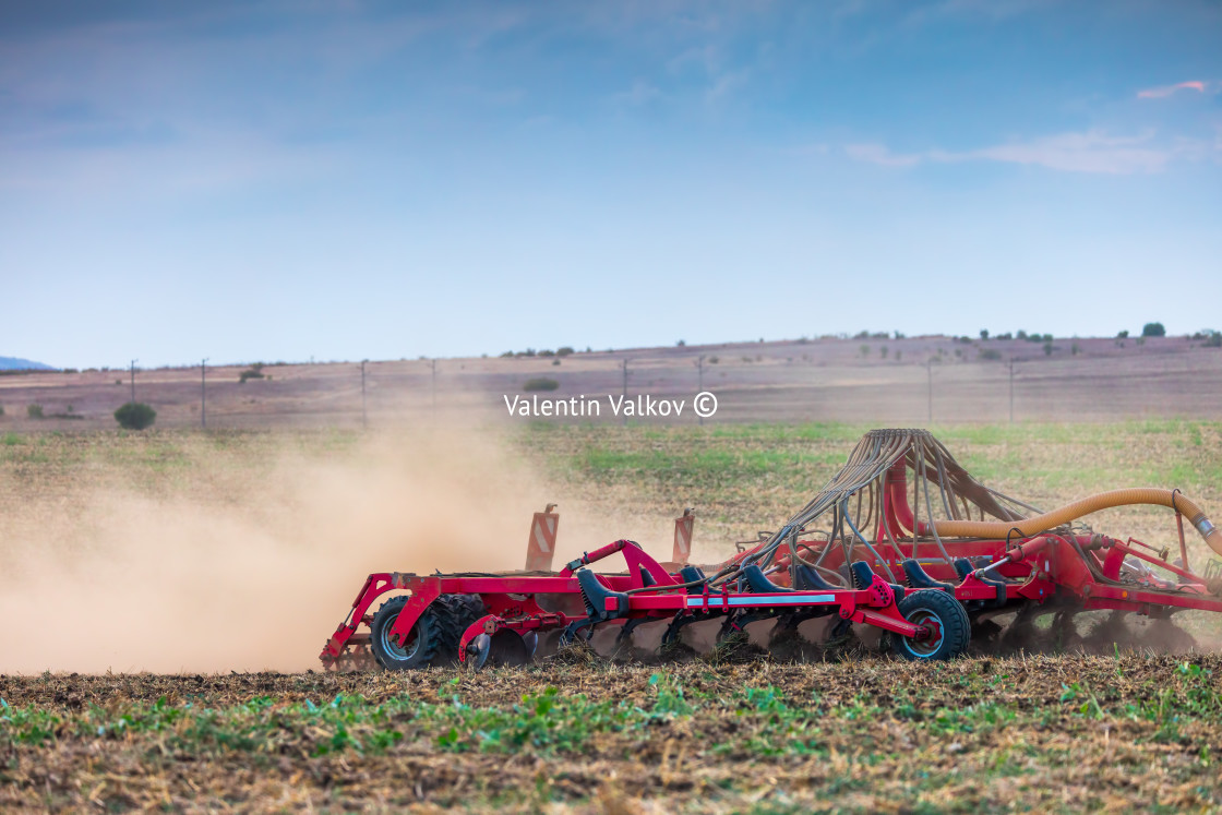 "Farmer in tractor preparing land with seedbed cultivator" stock image