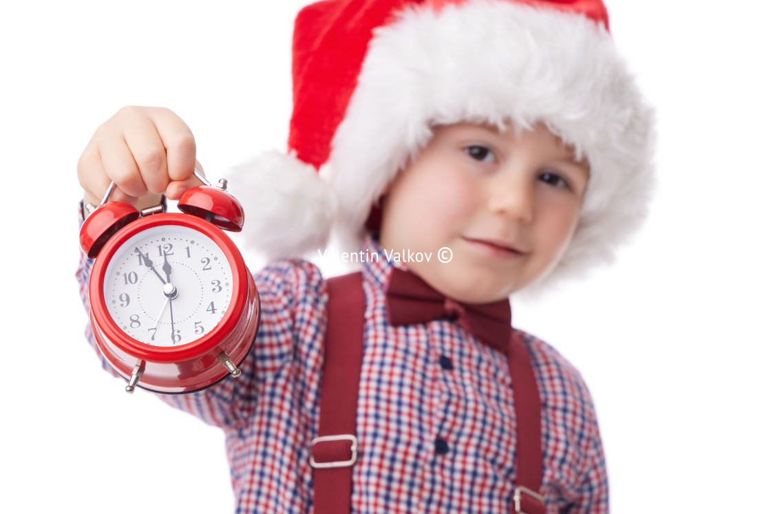 "Christmas boy with red alarm clock, smiling little man in red Sa" stock image