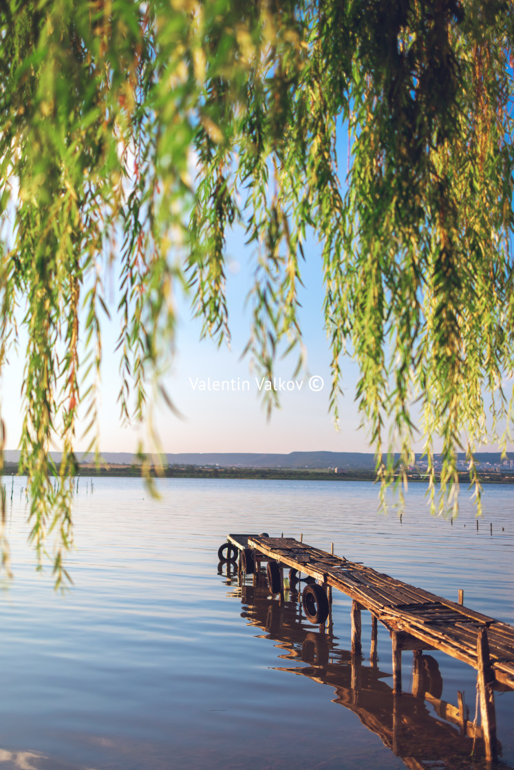 "Sunset over the sea lake and old wooden pier, romantic travel de" stock image