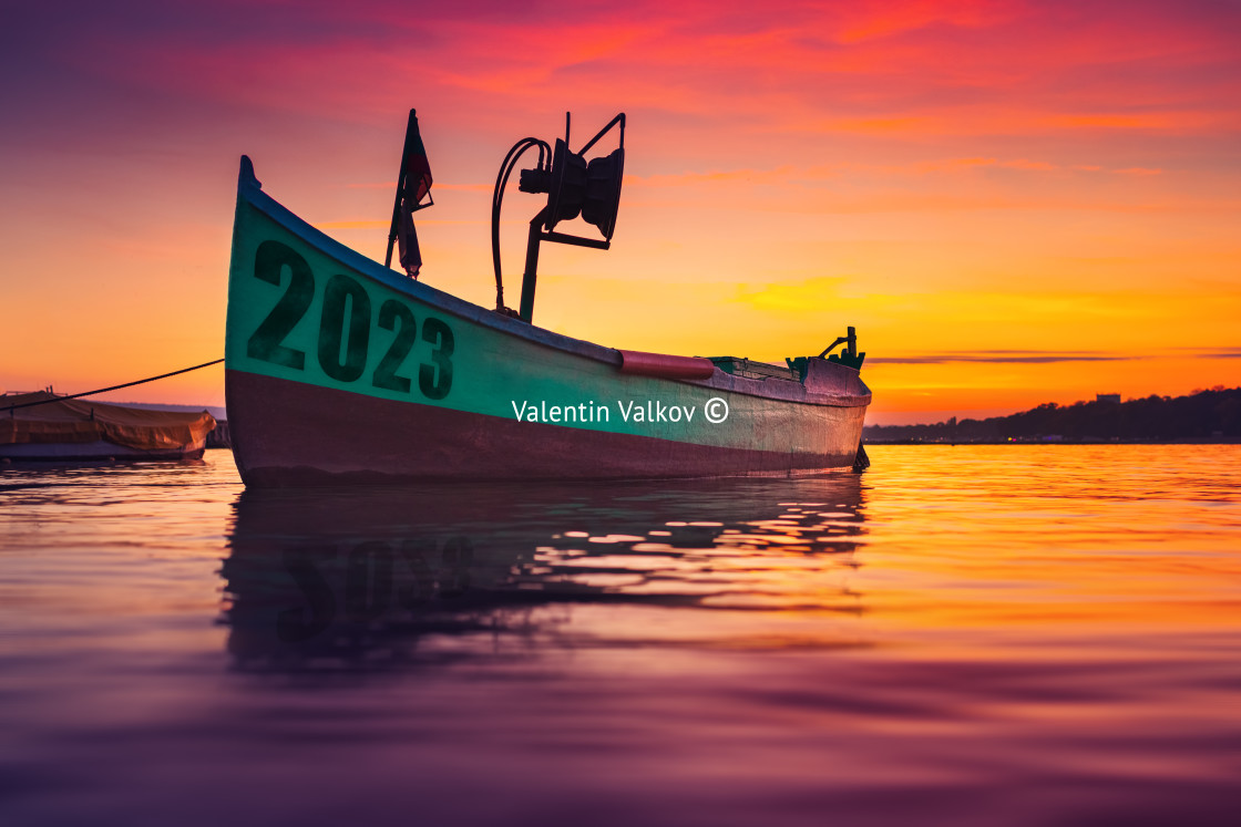 "2023 concept. Fishing boat on shore and ripple sea water on dram" stock image