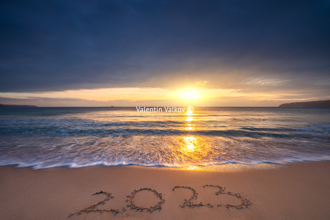 "Happy New Year 2023 concept, lettering on the beach. Written tex" stock image