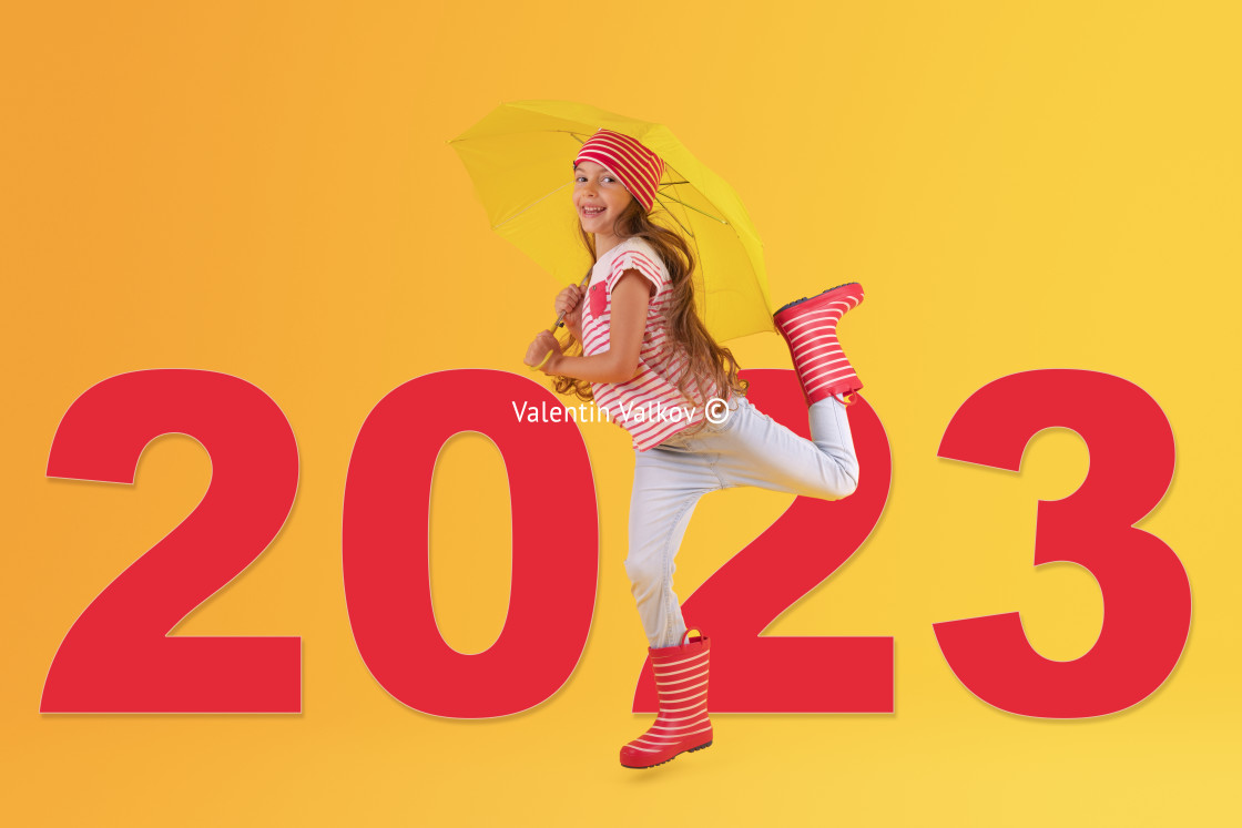 "2023 concept of Girl with red rubber boots for rain over yellow" stock image