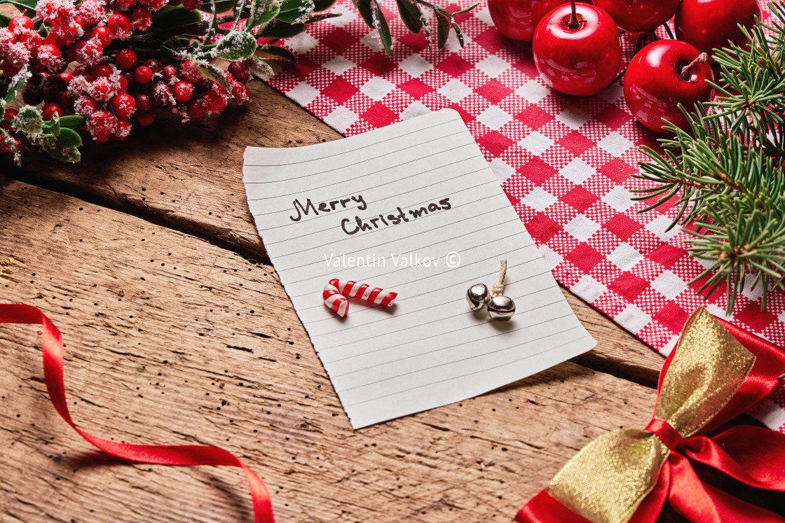 "Merry Christmas text card or letter on wooden desk with holiday" stock image