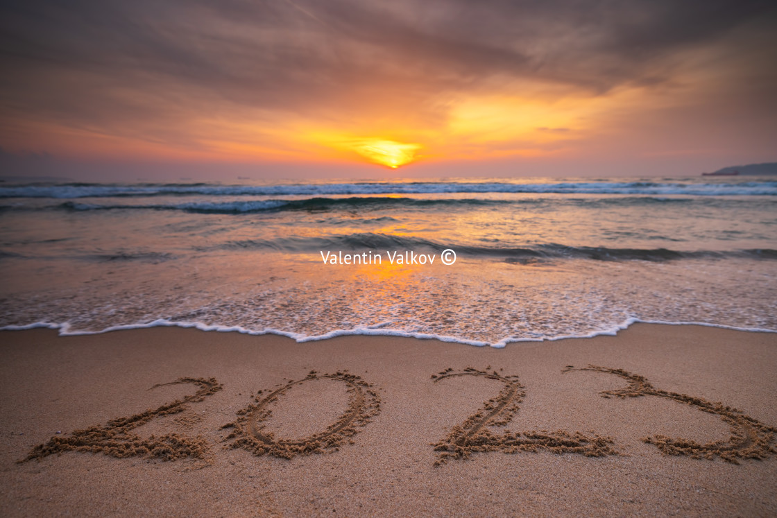 "Happy New Year 2023 concept, lettering on the beach. Written tex" stock image