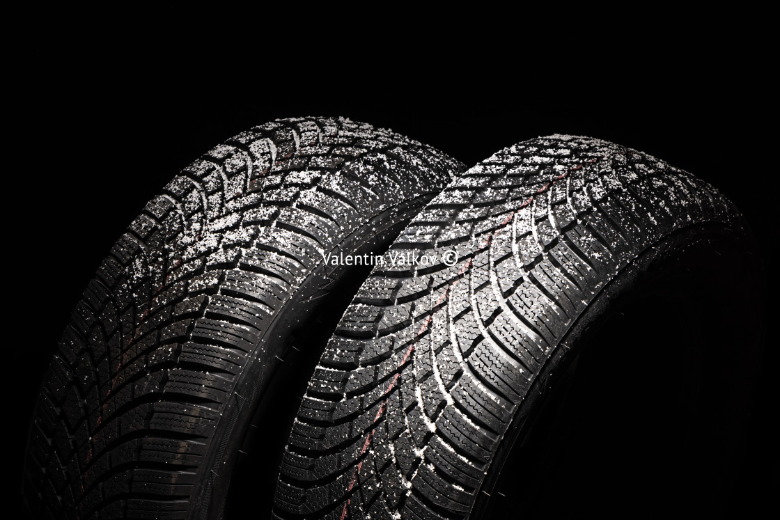 "Winter Car tire with snow on black background. Tyre and snowflak" stock image