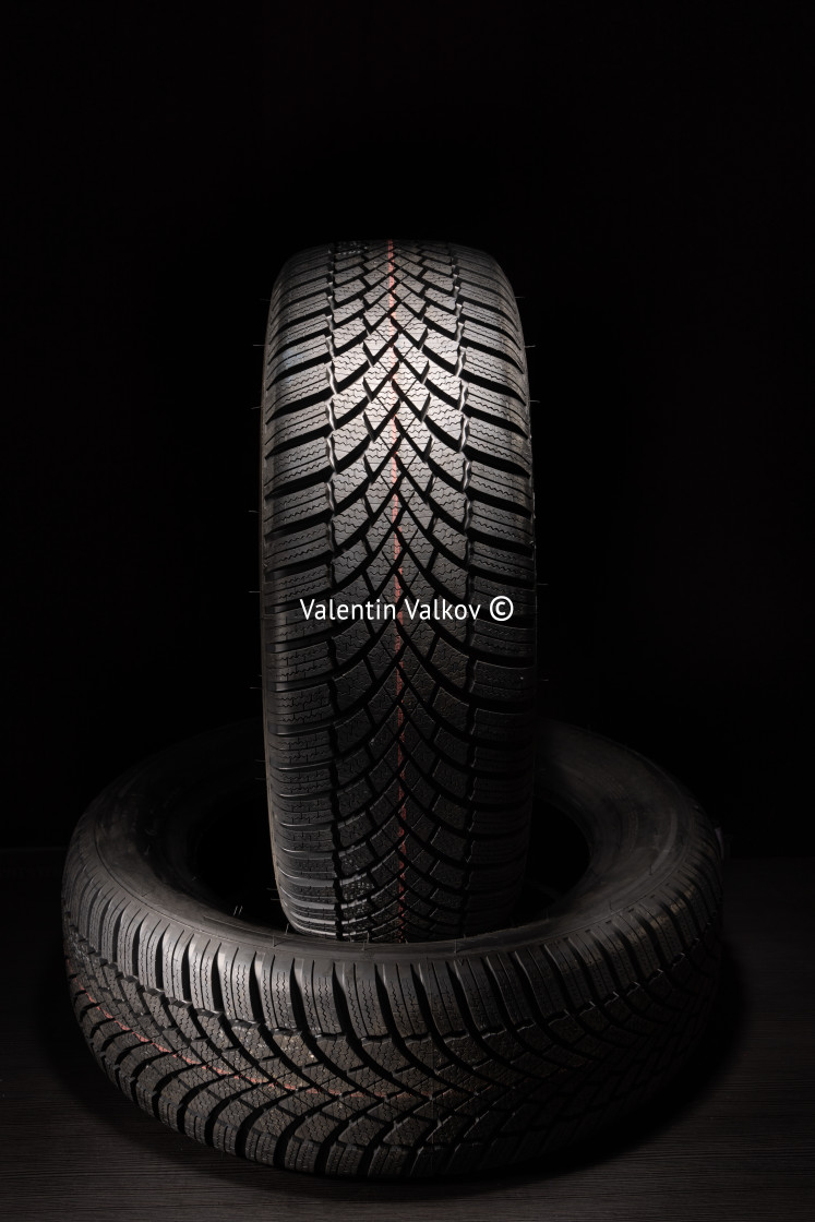 "Car tire, new tyre on black background with copy space for text" stock image