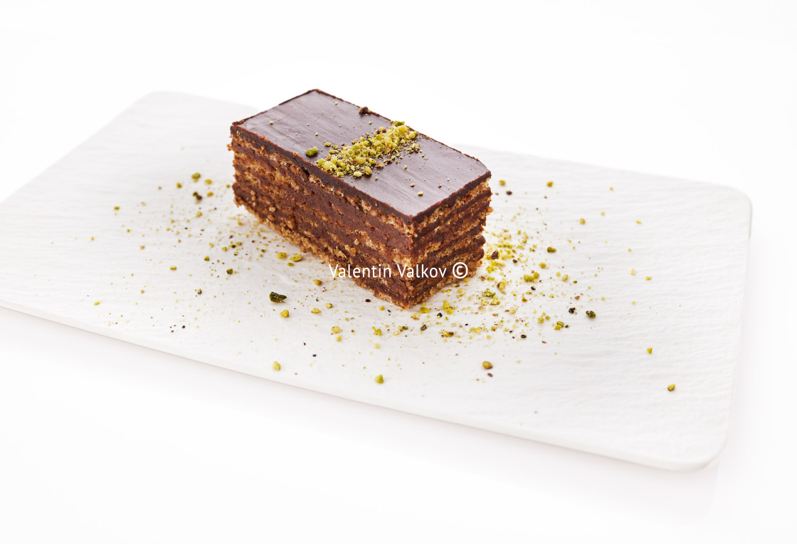 "Chocolate cake with walnuts and pistachio isolated on white back" stock image