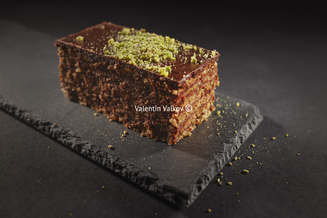 "Chocolate cake with walnuts and pistachio isolated on black back" stock image