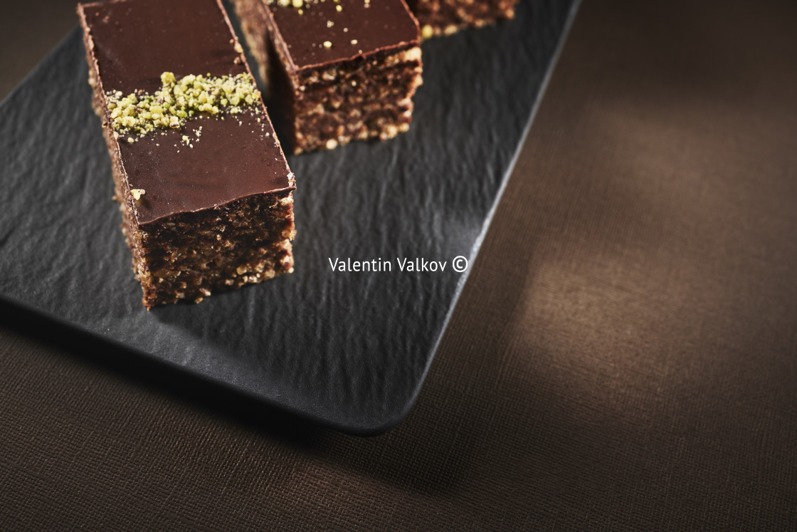 "Chocolate cake with walnuts and pistachio isolated on black back" by Valentin Valkov - $38.02 "Chocolate cake with walnuts and pistachio isolated on black back" stock image