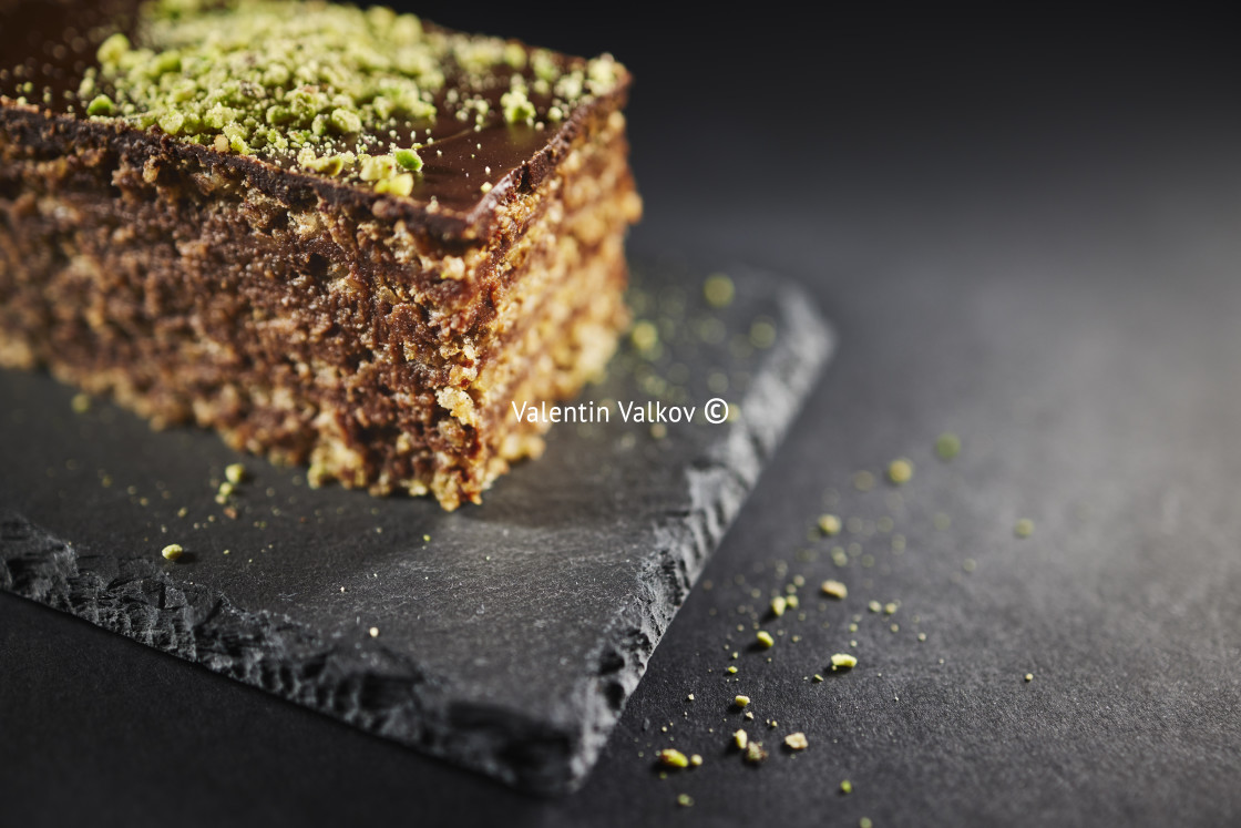 "Chocolate cake with walnuts and pistachio isolated on black back" stock image