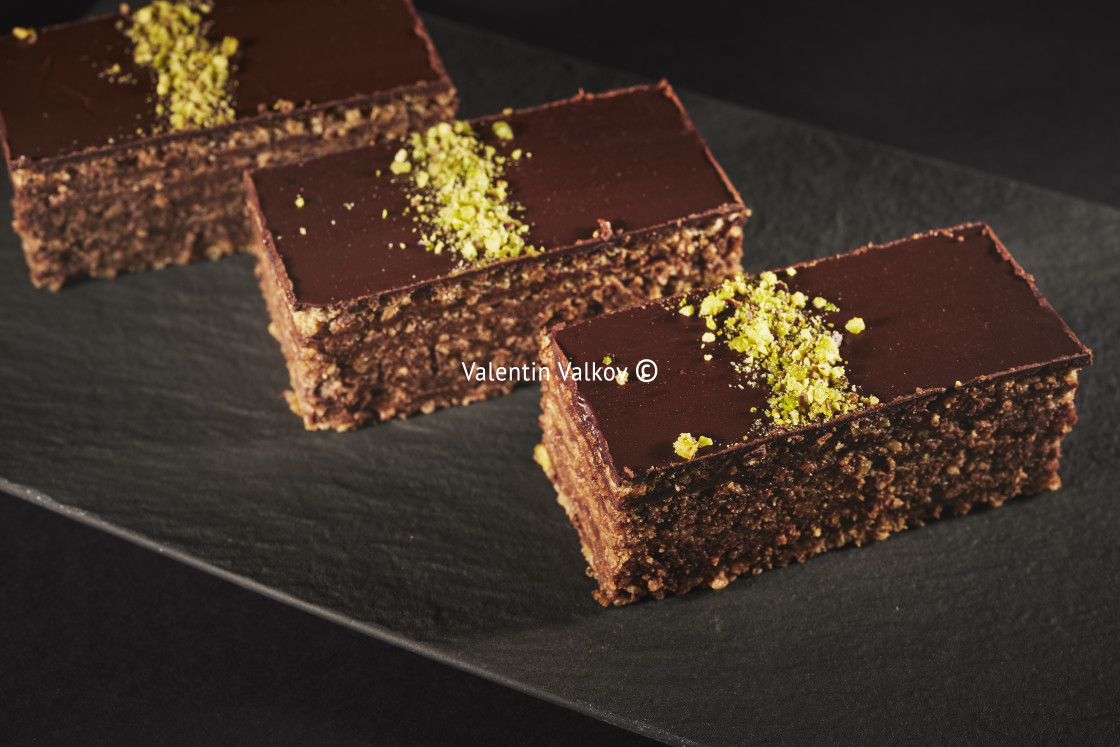 "Chocolate cake with walnuts and pistachio isolated on black back" by Valentin Valkov - $24.83 "Chocolate cake with walnuts and pistachio isolated on black back" stock image