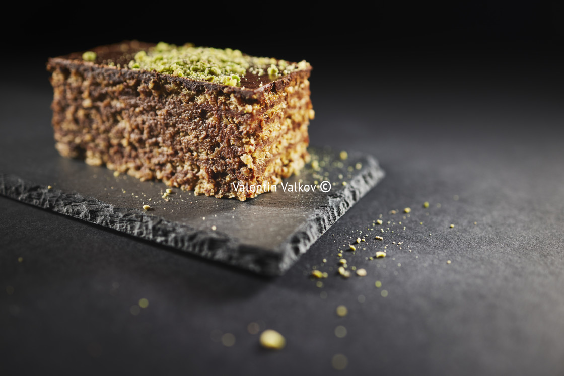 "Chocolate cake with walnuts and pistachio isolated on black back" stock image