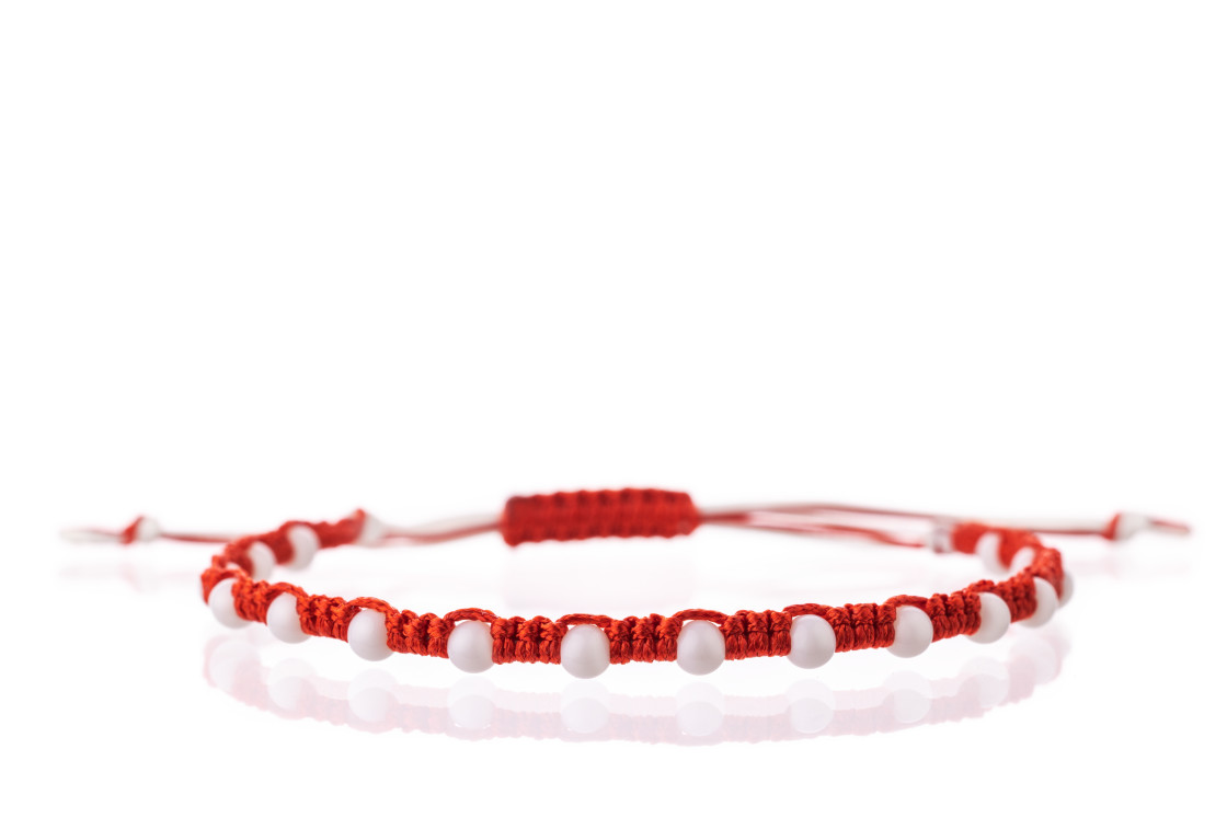 "Martisor talisman, martenitsa, martenitza for 1 March Baba Marta isolated on white background. Traditional accessory for holiday of early spring in Bulgaria, Romania, Moldova. Red and White yarn strin" stock image