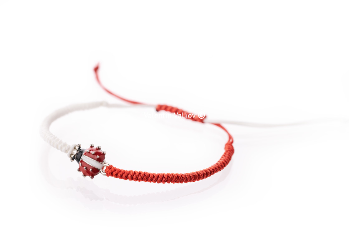 "Martisor talisman, martenitsa, martenitza for 1 March Baba Marta isolated on white background. Traditional accessory for holiday of early spring in Bulgaria, Romania, Moldova. Red and White yarn strin" stock image