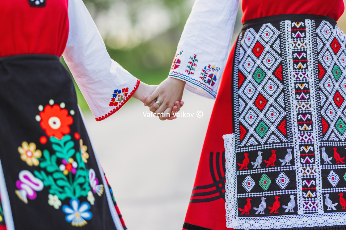 "Girls in traditional bulgarian ethnic costumes with folklore embroidery holding hands. The spirit of Bulgaria - culture, history and traditions." stock image