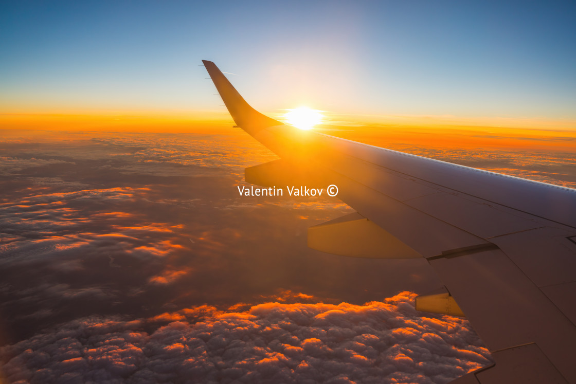 "Airplane flight in sunset sky over earth of city light and wing of plane. View from the window of the Aircraft. Traveling in air." by Valentin Valkov - $24.48 "Airplane flight in sunset sky over earth of city light and wing of plane. View from the window of the Aircraft. Traveling in air." stock image