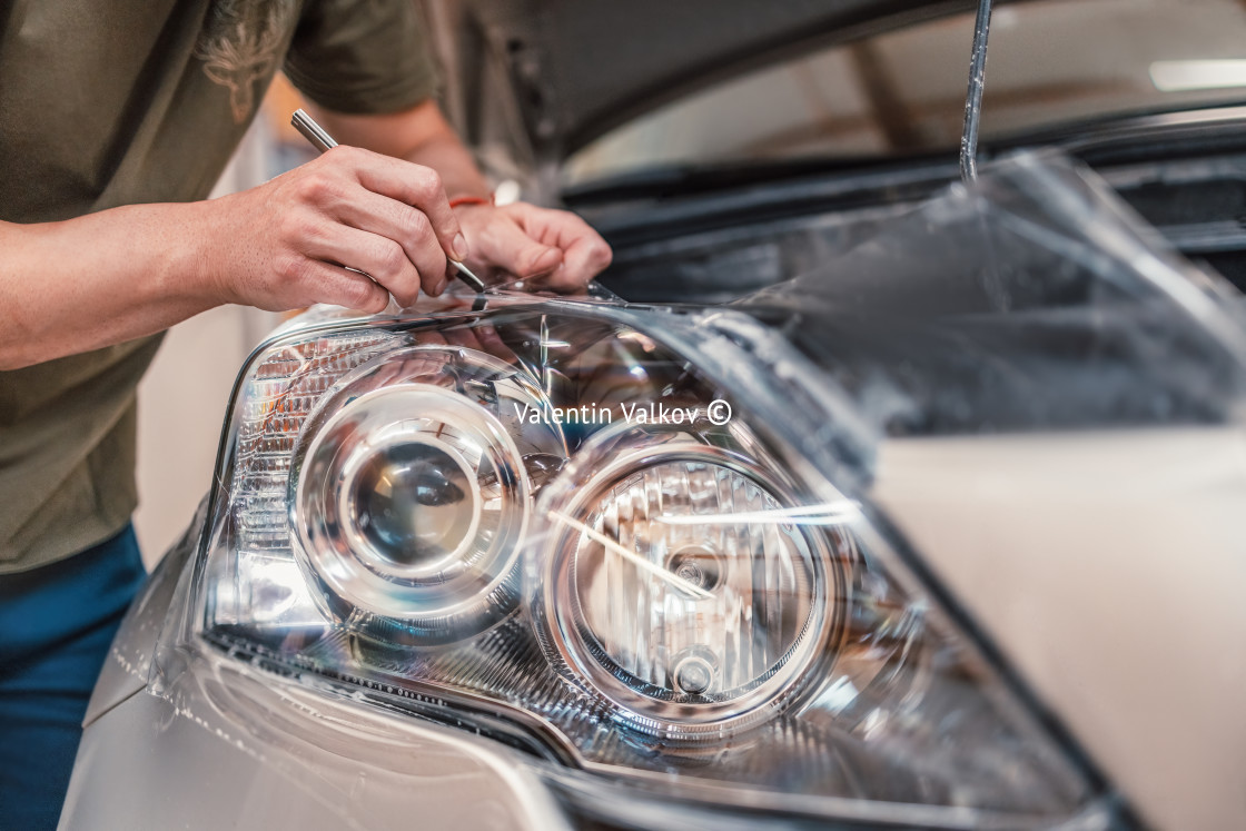 "Car tinting service - Worker specialist apply tint foil on car headlight in workshop" by Valentin Valkov - $24.48 "Car tinting service - Worker specialist apply tint foil on car headlight in workshop" stock image