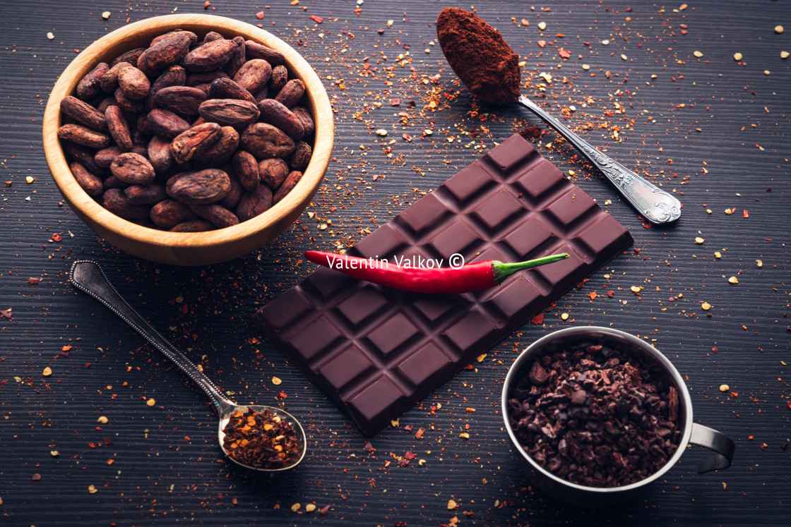 "Dark chocolate bar, red hot chilli pepper cayenne, dry hot chili spices, cocoa beans nibs powder, food tasty design on black wooden background" by Valentin Valkov - $24.48 "Dark chocolate bar, red hot chilli pepper cayenne, dry hot chili spices, cocoa beans nibs powder, food tasty design on black wooden background" stock image