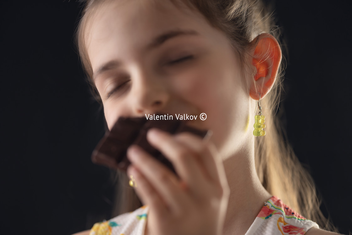 "Chocolate and pretty hungry little woman portrait. Beautiful girl ready to eat chocolate bar." by Valentin Valkov - $24.48 "Chocolate and pretty hungry little woman portrait. Beautiful girl ready to eat chocolate bar." stock image