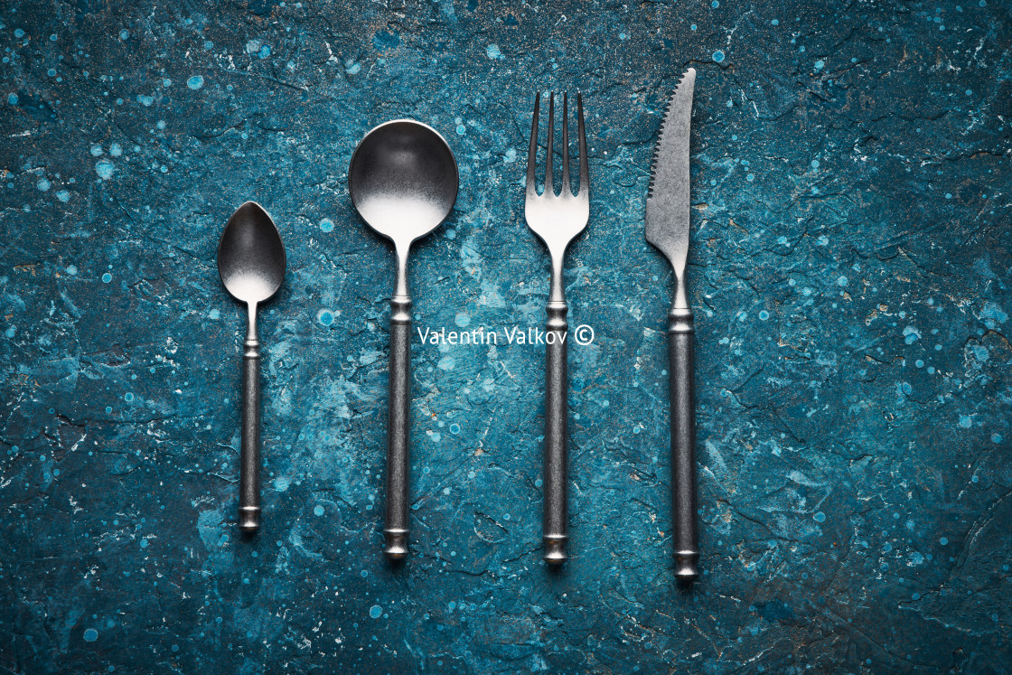 "Dark blue old vintage backdrop with kitchen utensils fork, knife, spoon and copy space for text," by Valentin Valkov - $38.02 "Dark blue old vintage backdrop with kitchen utensils fork, knife, spoon and copy space for text," stock image