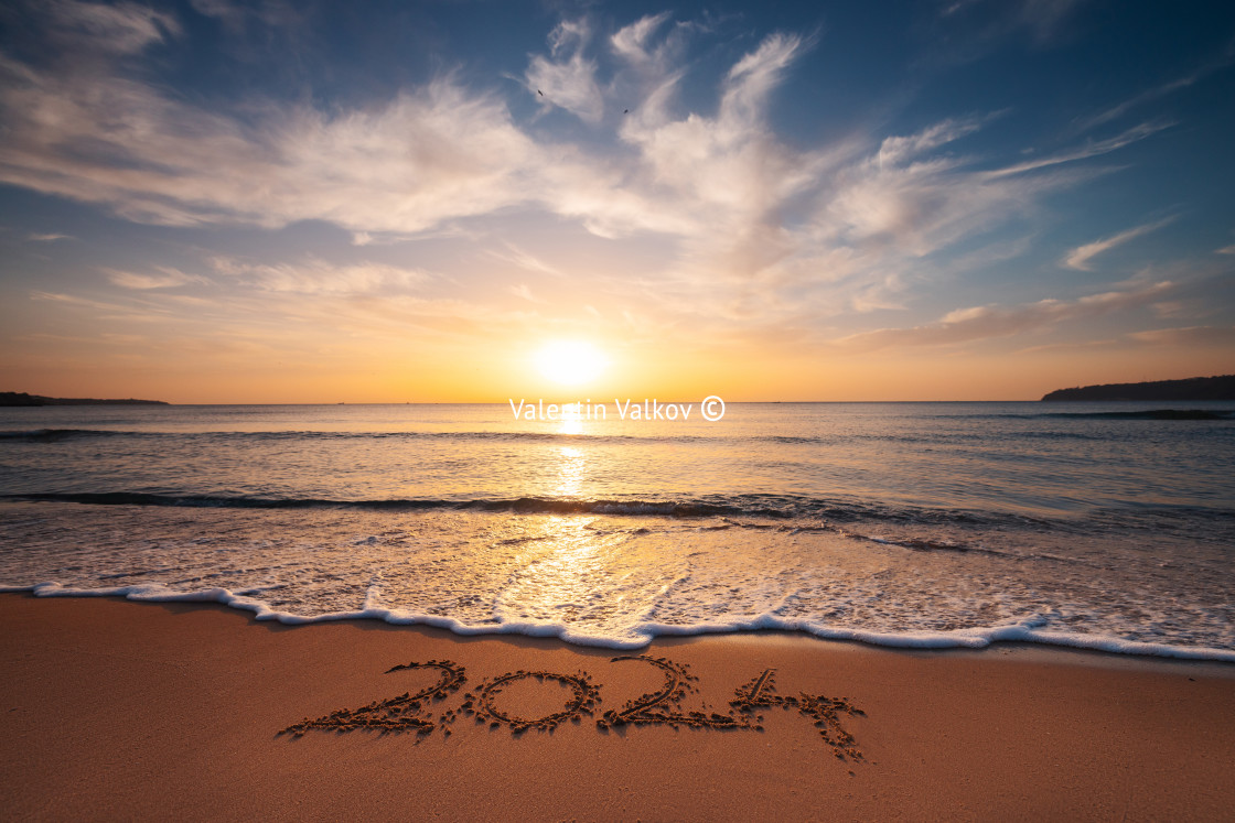 "Happy New Year 2024 concept, lettering on the beach. Written text on the sea beach at sunrise." stock image