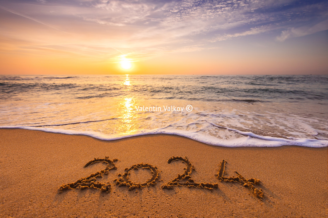 "Happy New Year 2024 concept, lettering on the beach. Written text on the sea beach at sunrise." stock image