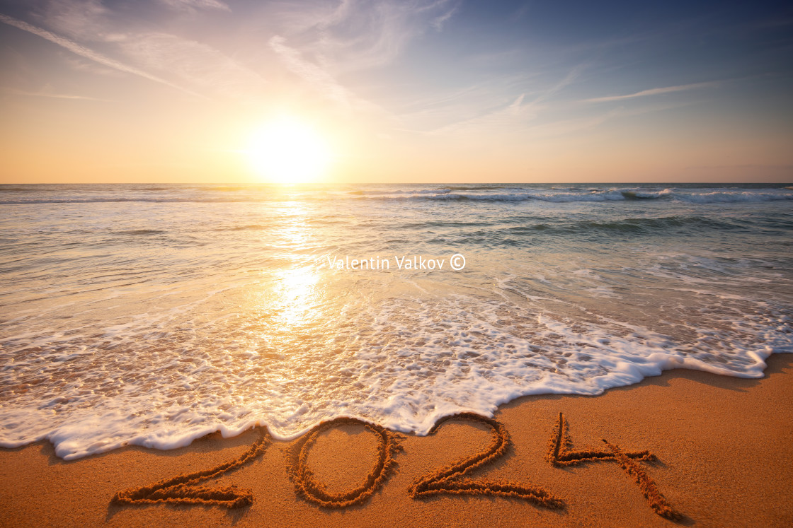 "Happy New Year 2024 concept, lettering on the beach. Written text on the sea beach at sunrise." stock image