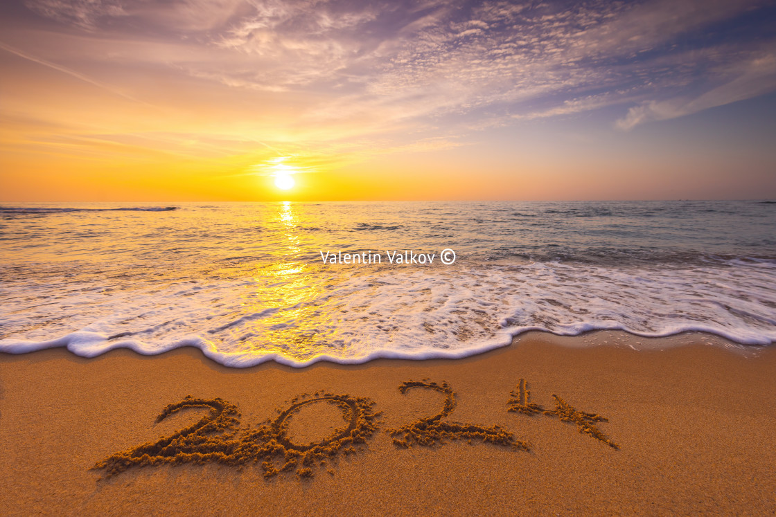 "Happy New Year 2024 concept, lettering on the beach. Written text on the sea beach at sunrise." stock image