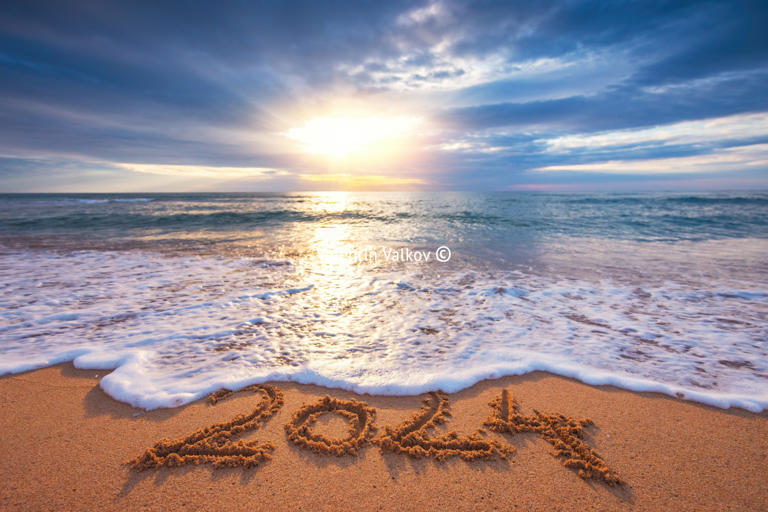 "Happy New Year 2024 concept, lettering on the beach. Written text on the sea beach at sunrise." stock image