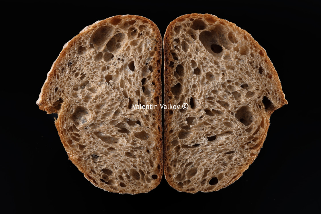 "Homemade sourdough bread baguette on black beackground." stock image