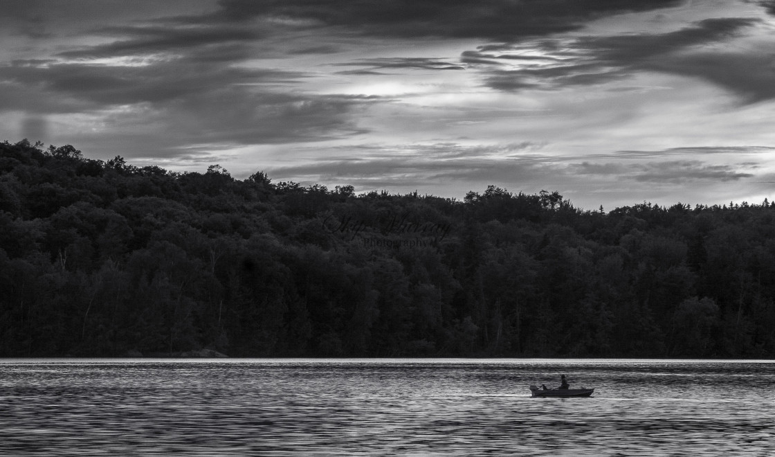 "Lone boat on lake" stock image