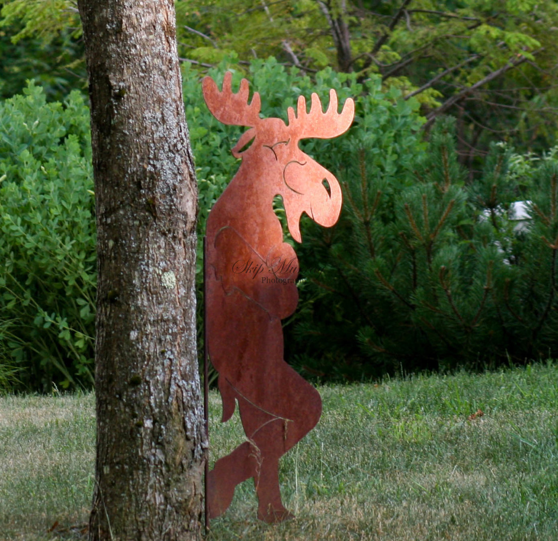 "Moose leaning against tree" stock image