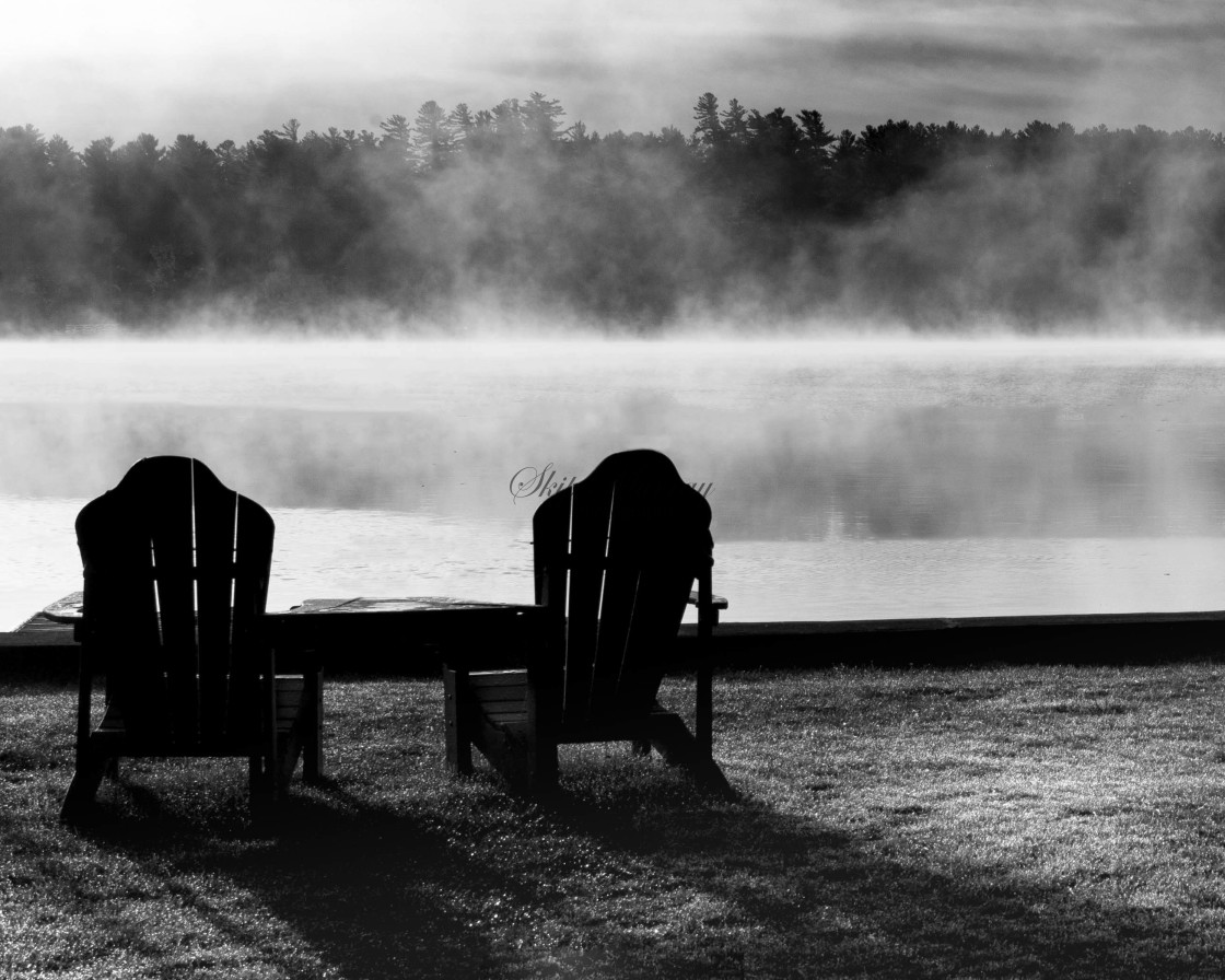 "Adirondack Chairs next to misty lake" stock image