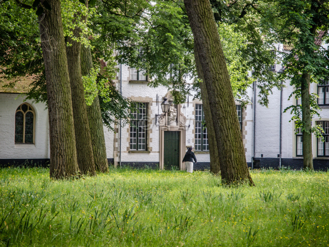 "Begijnhof courtyard with nun" stock image