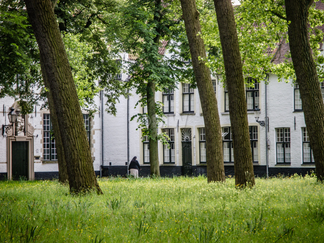 "Begijnhof courtyard with nun" stock image