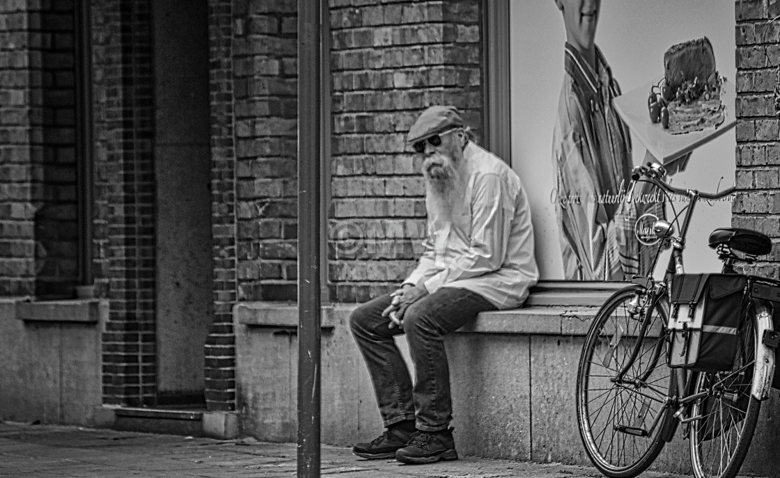 "Bearded old man on bench" stock image