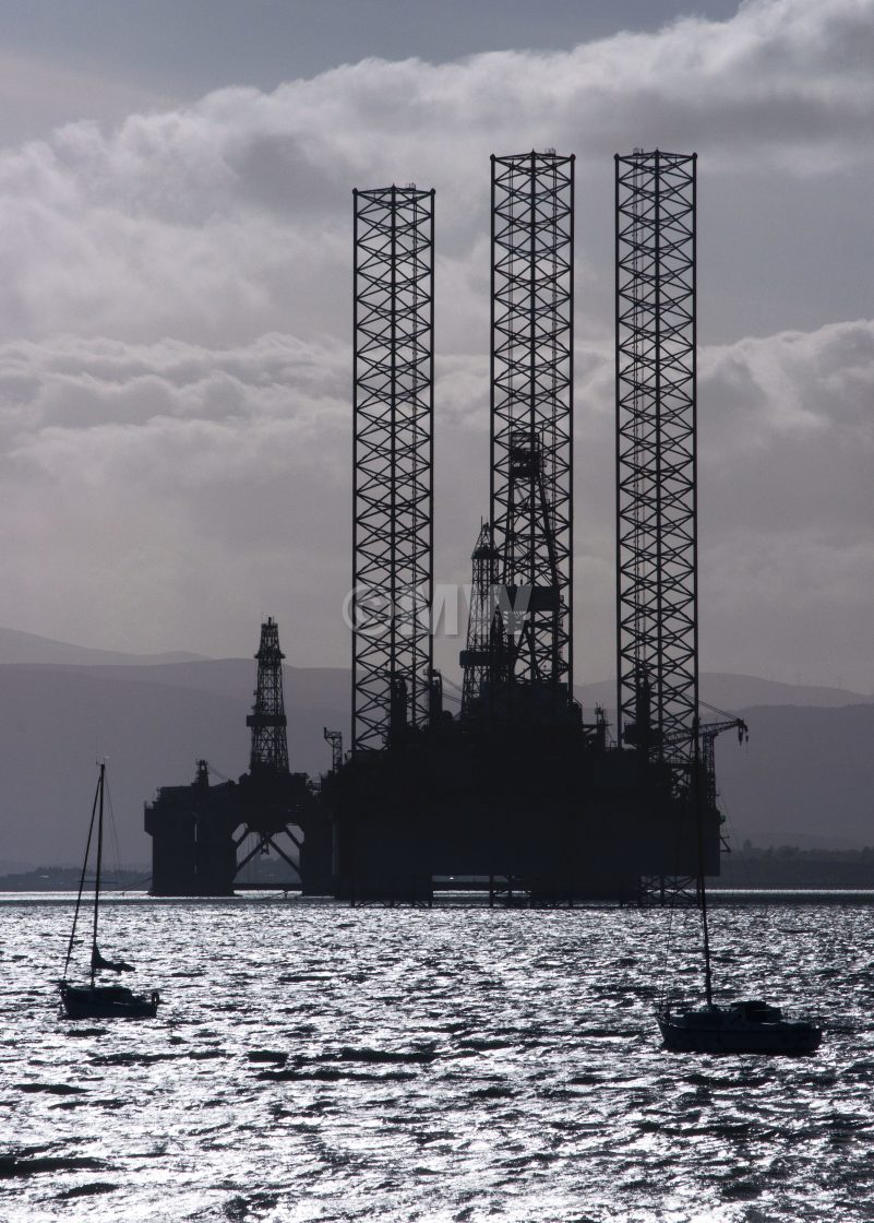 "Oil platform maintenance + sailboats" stock image