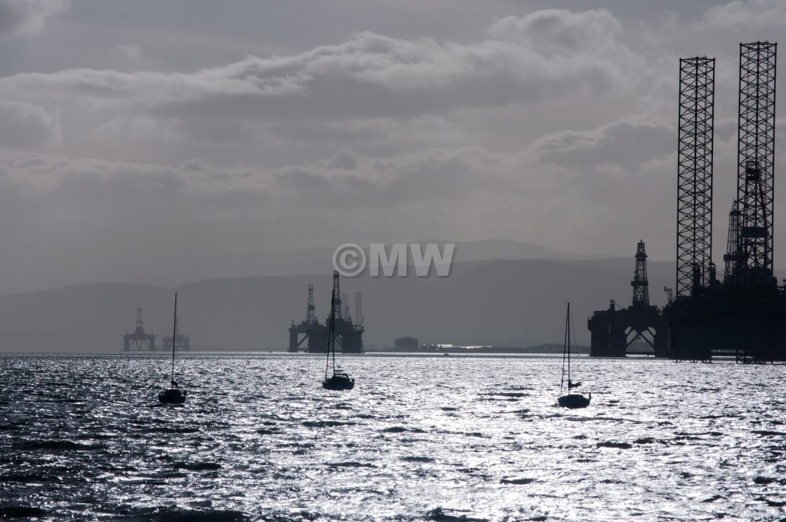 "Oil rigs and small boats on Cromarty Firth" stock image