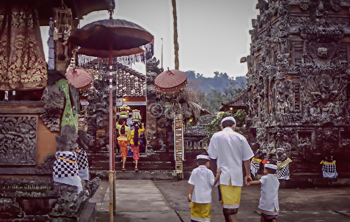 "Man & boys enter Pura Manik Tirta temple." stock image