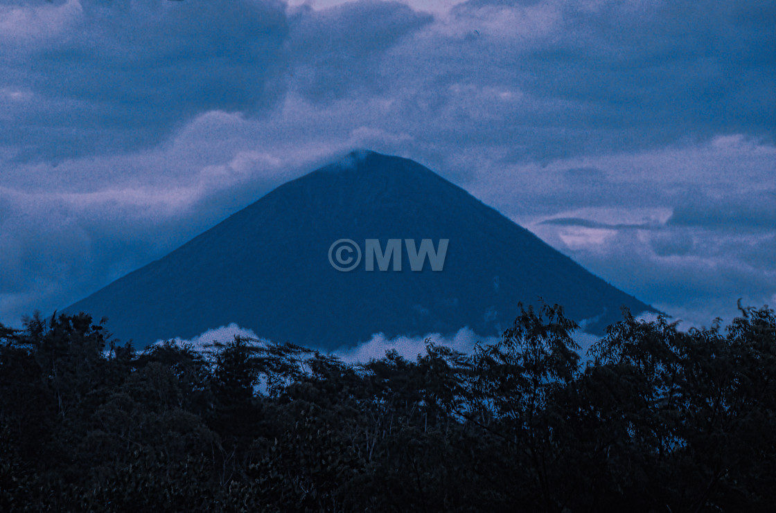 "Mt. (Gunung) Agung with trees & clouds" stock image