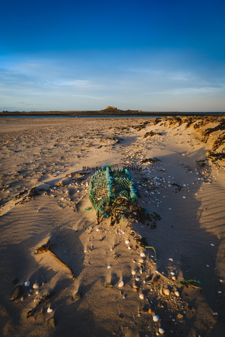 "Lobster Crate at Ross Sands with Lindisfarne in the background" by Photography by Philip - $14.95 "Lobster Crate at Ross Sands with Lindisfarne in the background" stock image