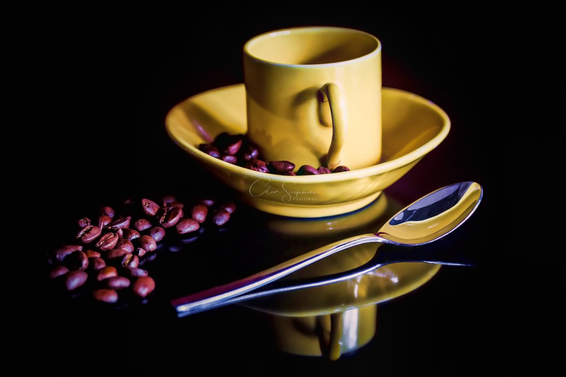 "Coffee cup and beans on a reflective surface" stock image