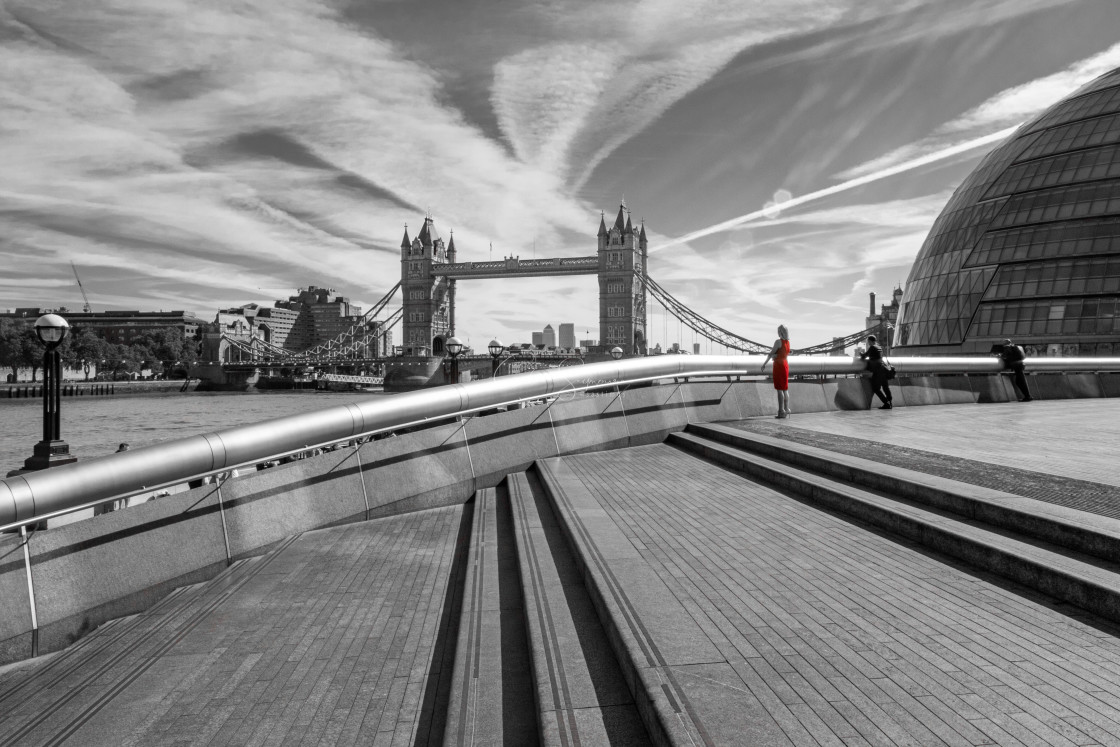 "Girl in Red dress looking towards Tower bridge" stock image