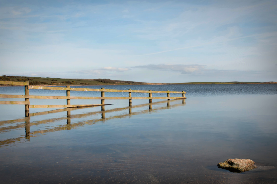 "Wooden fence Disappearing into a lake" stock image