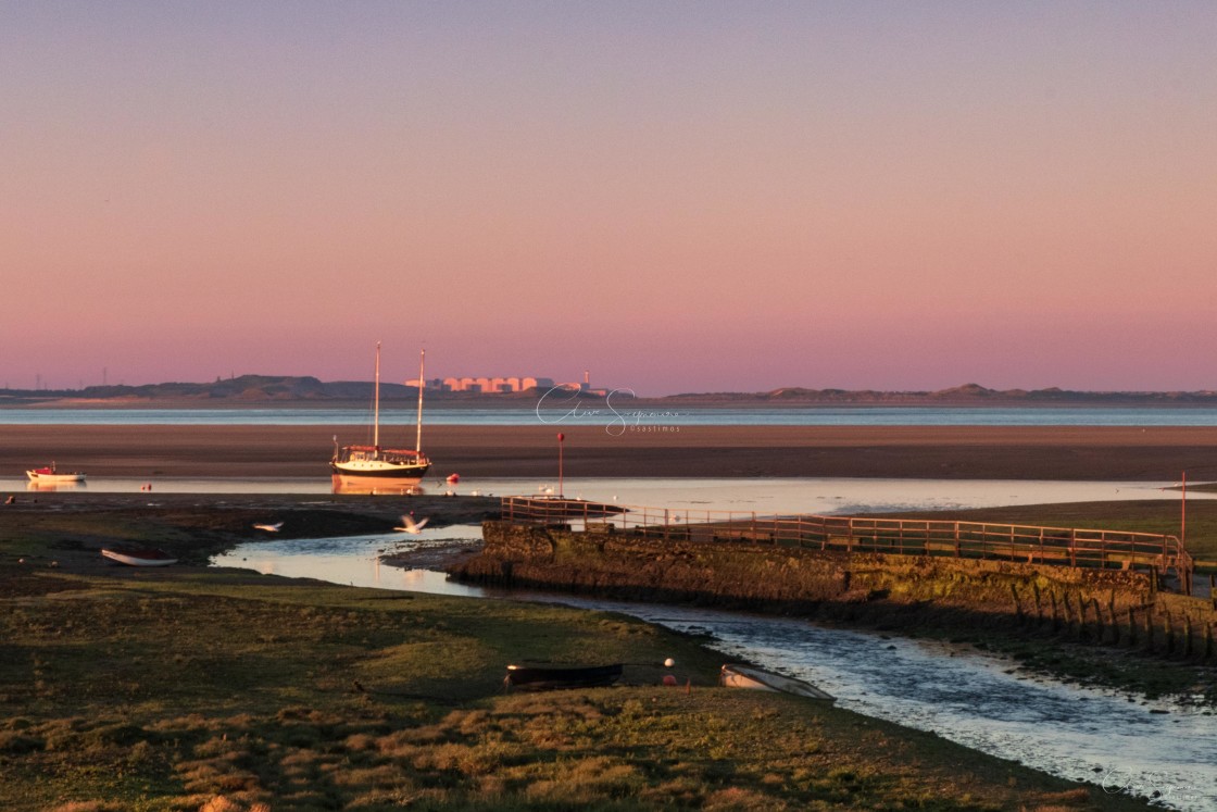 "Early morning by river estuary with boat and reflections." stock image