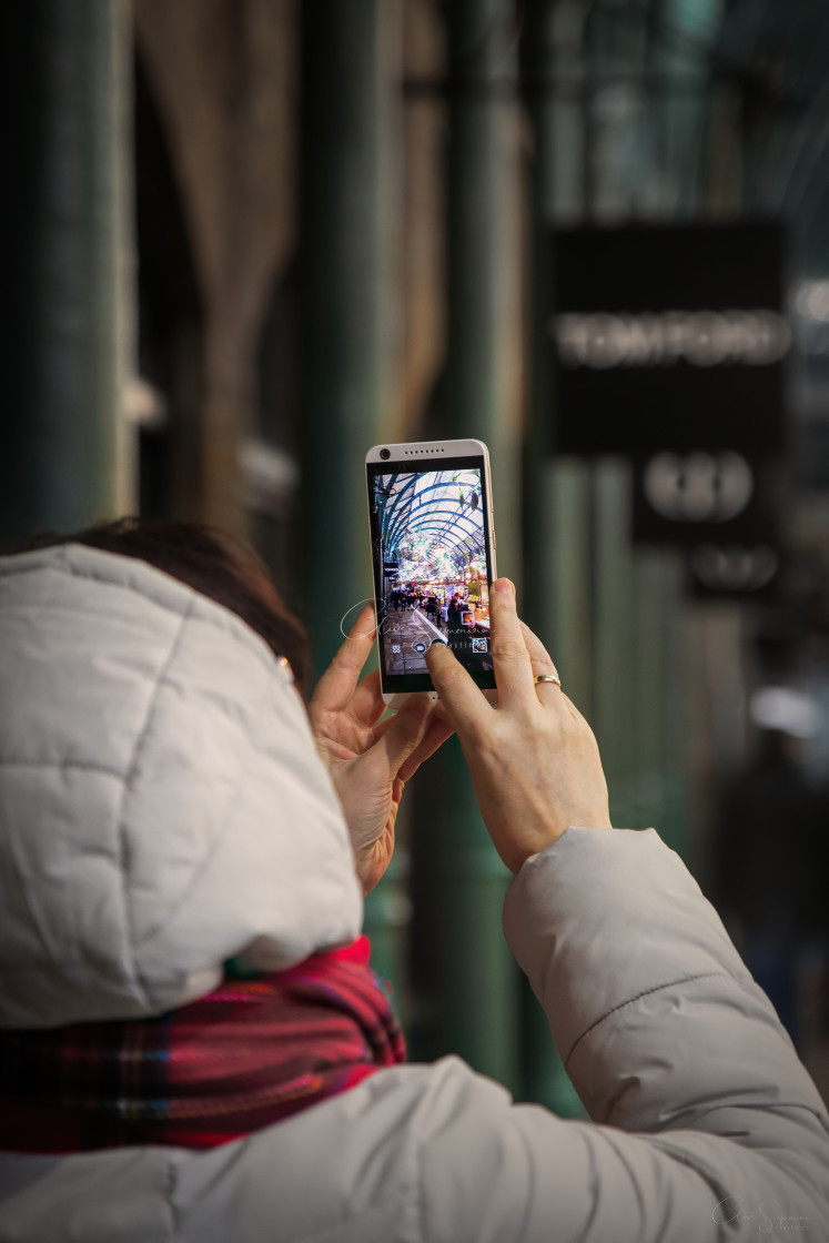 "Tourist in Covent Garden, London, taking a picture" stock image